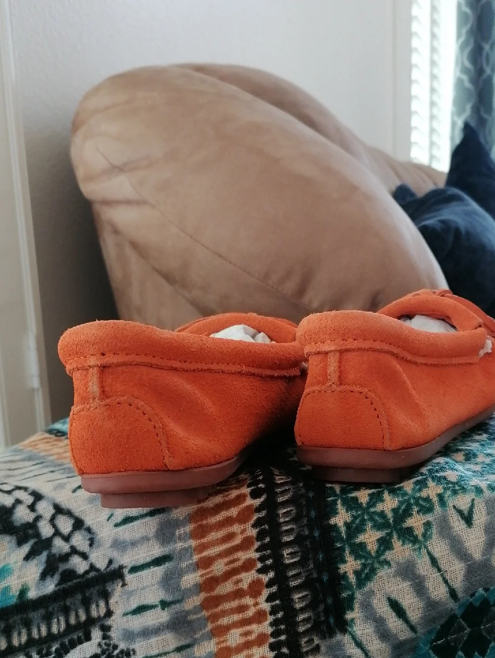 Minnetonka  Orange soft suede hard sole Moccasin.Never worn. Runs  big 5.5 = 6.5